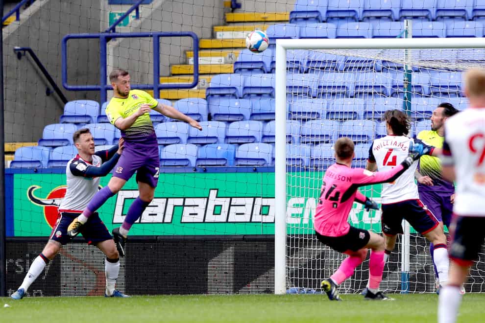 Exeter defender Pierce Sweeney (left) scores his side’s winning goal at Bolton