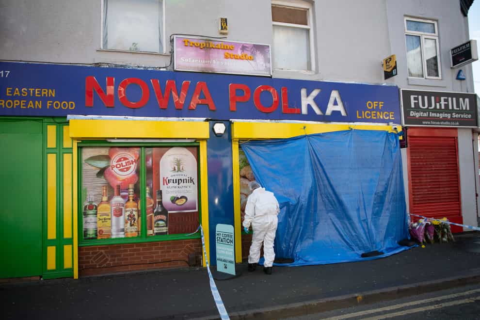 Forensic officers enter a shop on Waterloo Road, Smethwick