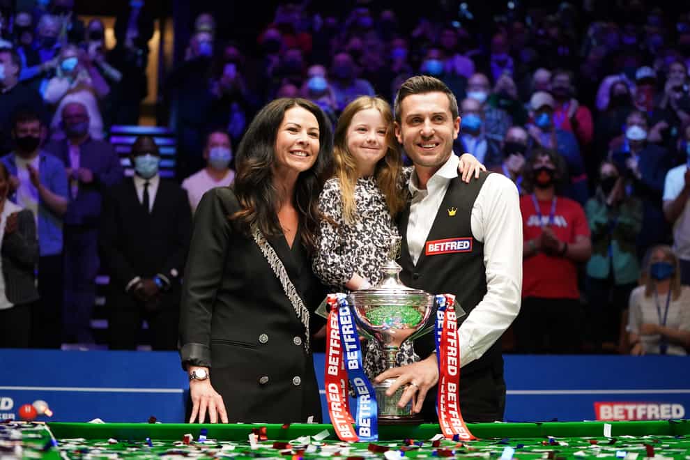 Mark Selby celebrates with his wife and daughter after winning the world title for a fourth time