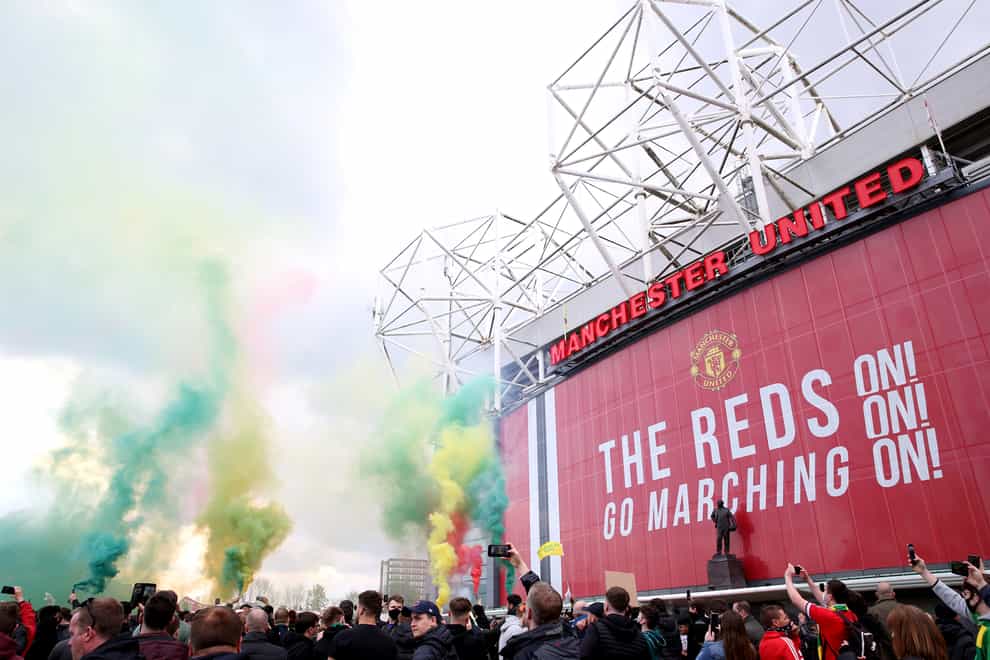 Fans let off flares as they protested against the Glazer family