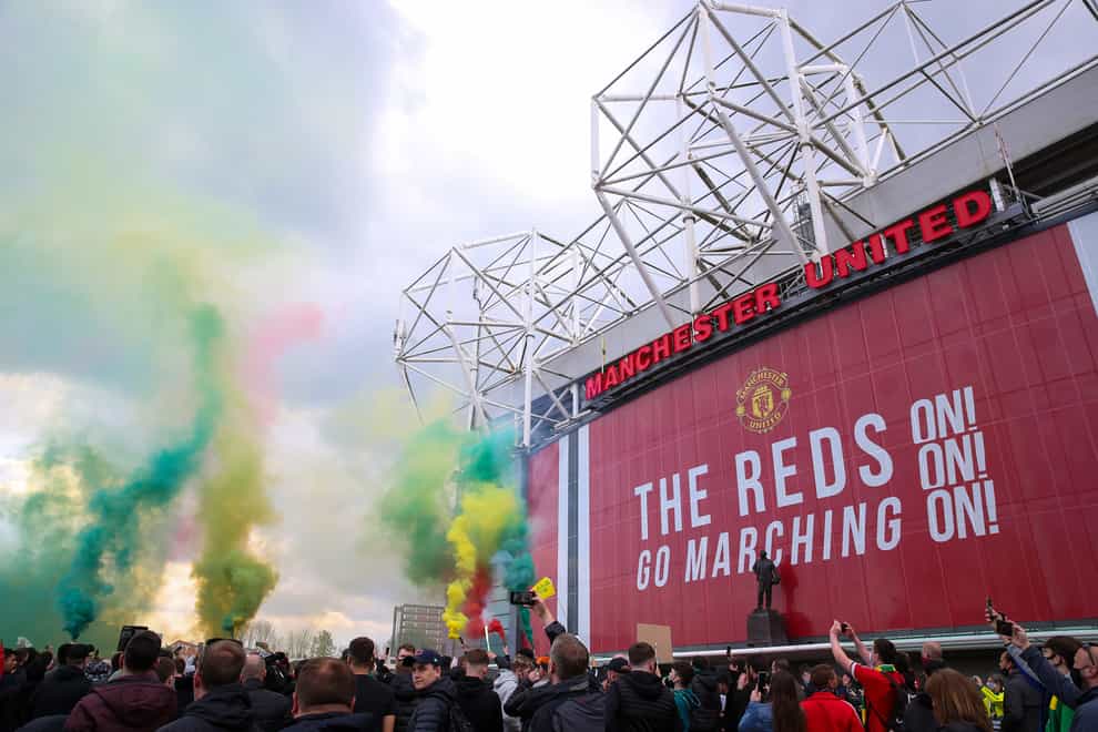 Manchester United fans let off flares as they protest against the Glazer family