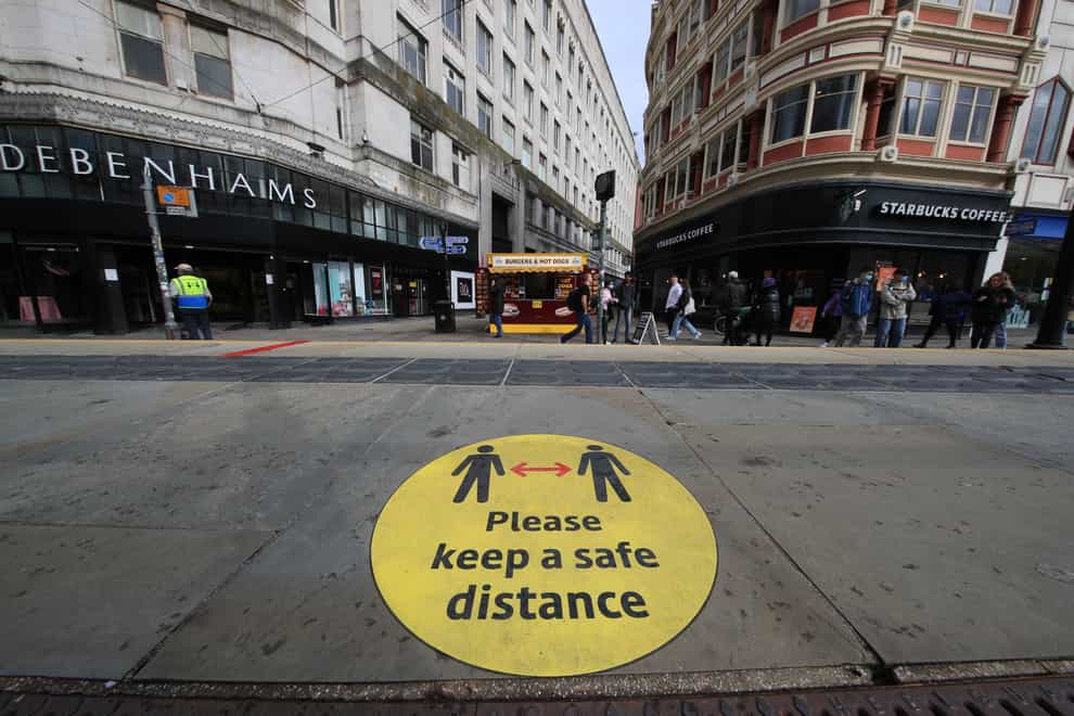 A social distancing sign on a pavement in Manchester
