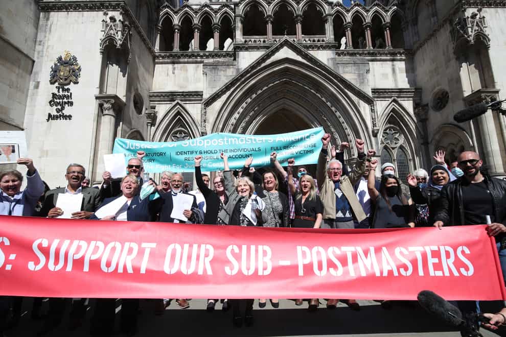Former Post Office workers celebrate outside the Royal Courts of Justice