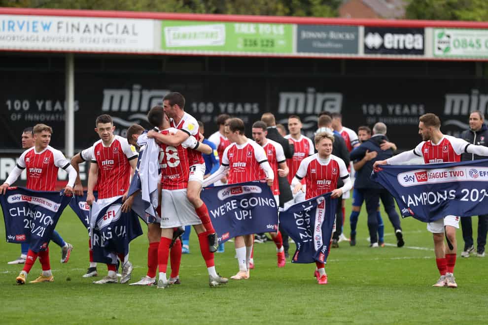 Cheltenham's players celebrate becoming League Two champions