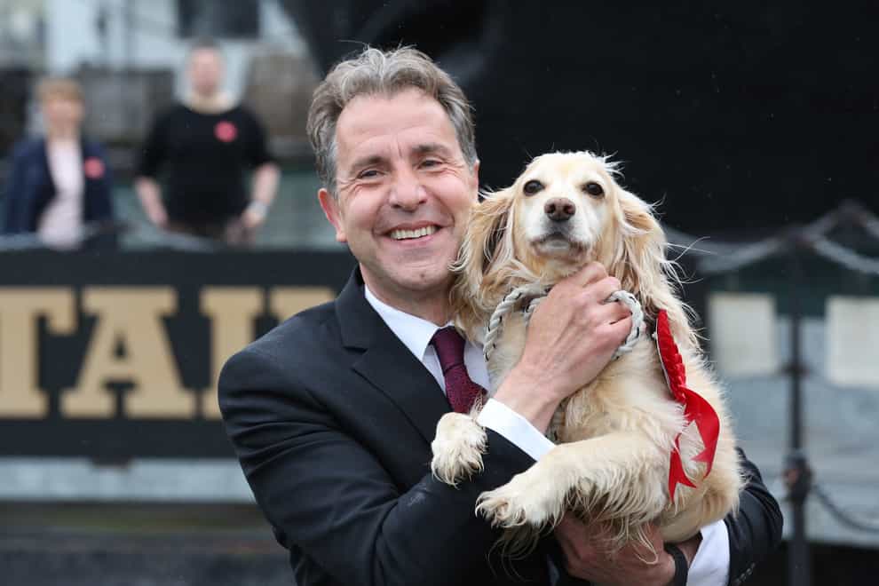 Dan Norris celebrating with his dog Angel at the SS Great Britain in Bristol (West of England Combined Authority/PA)