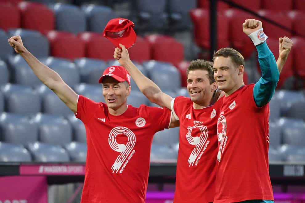 Robert Lewandowski (left), Thomas Muller (centre) and Manuel Neuer celebrate Bayern Munich's title win