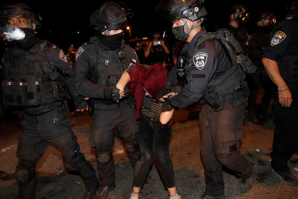 Israeli police officers detain a Palestinian demonstrator during a protest against the planned evictions of Palestinian families in the Sheikh Jarrah neighbourhood of east Jerusalem