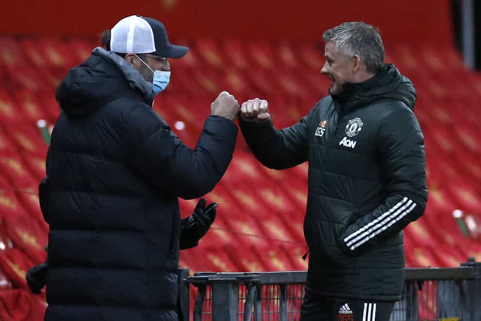 Liverpool manager Jurgen Klopp (left) fist bumps Manchester United manager Ole Gunnar Solskjaer