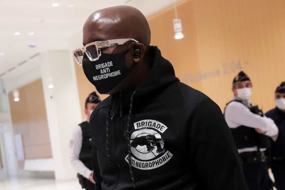 Franco Lollia, wears a face mask reading Anti-Negrophobia Brigade as he arrives at the Paris courthouse