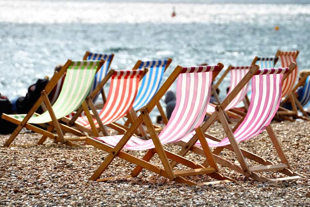 Deckchairs on Brighton beach in summer, Sussex, England, UK