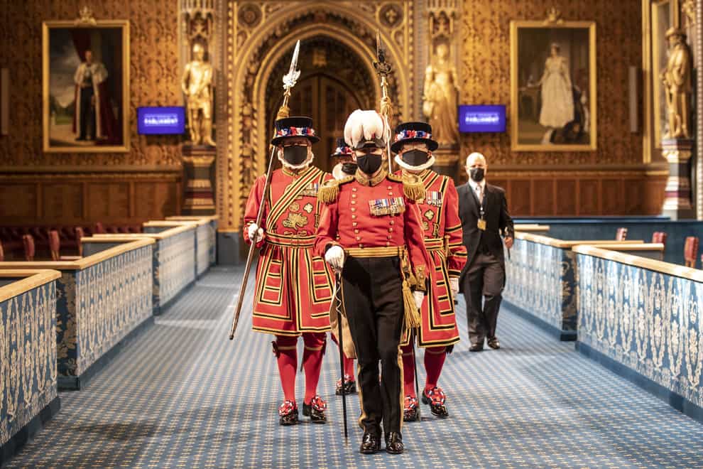 Masked Yeoman Warders march along the Royal Gallery during the ceremonial search of the Palace of Westminster ahead of the State Opening of Parliament by the Queen