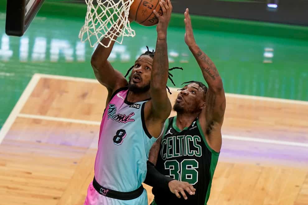 Miami Heat’s Trevor Ariza (8) drives to the basket as Boston Celtics’ Marcus Smart tries to block