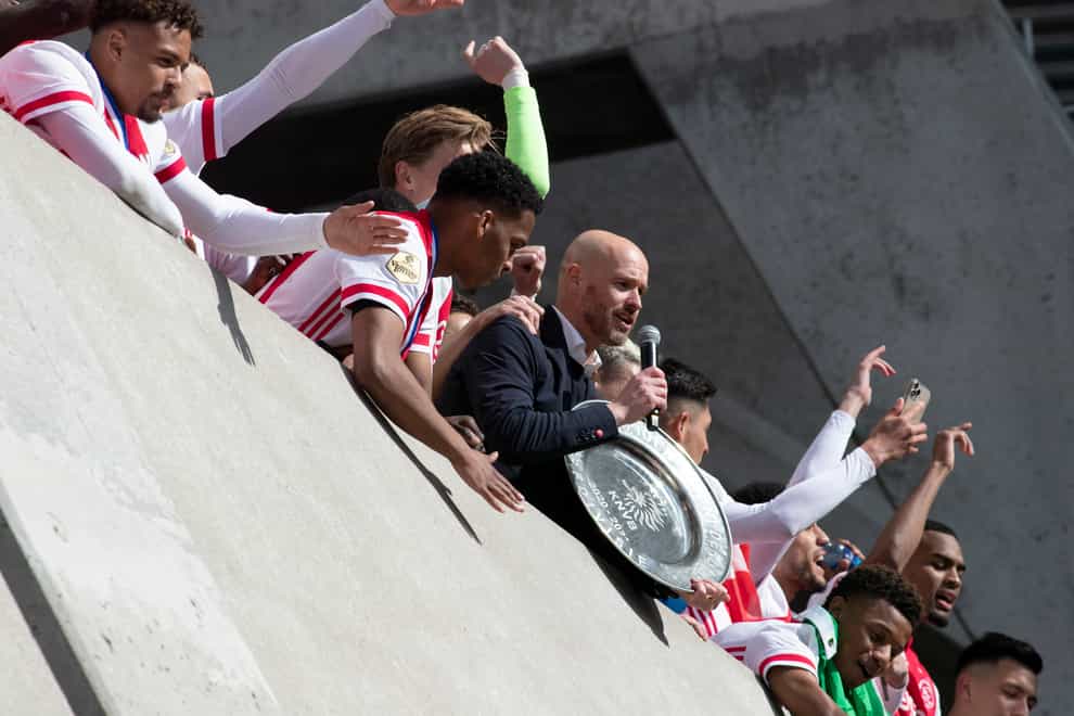 Ajax coach Erik ten Hag and players hold the trophy as they celebrate clinching the Dutch Eredivisie Premier League title at the Johan Cruyff ArenA in Amsterdam, Netherlands