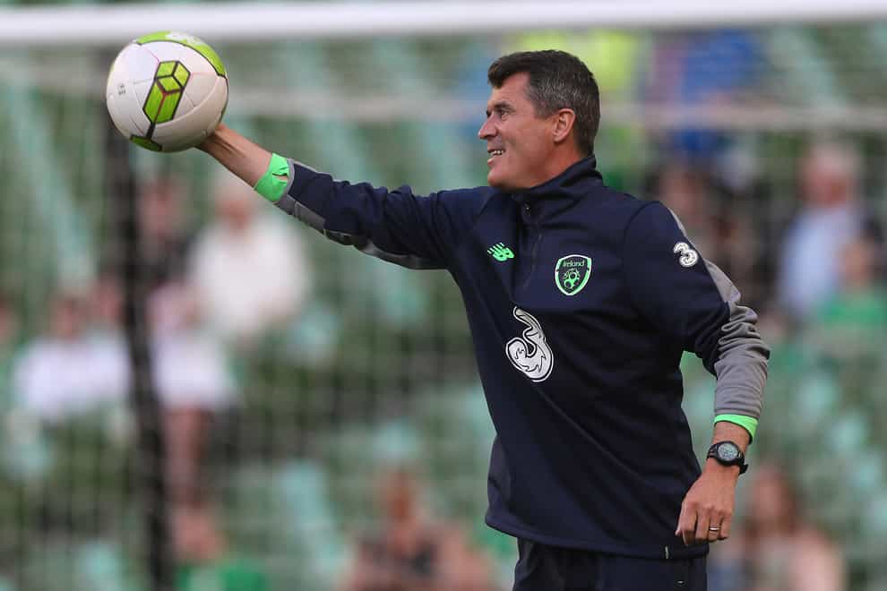 Roy Keane catches a football