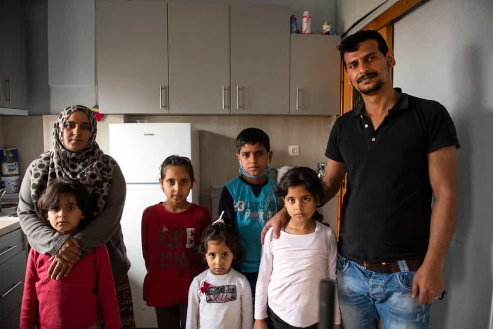Abdul Salam Al Khawien and his wife Kariman with their children at their apartment in Thessaloniki, Greece