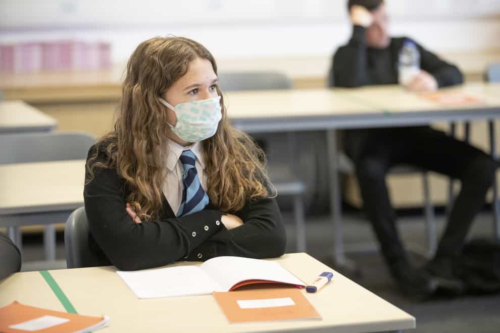 A student wears a protective face mask as the requirement for secondary school pupils to wear face coverings when moving around school comes into effect from today across Scotland (Jane Barlow/PA)