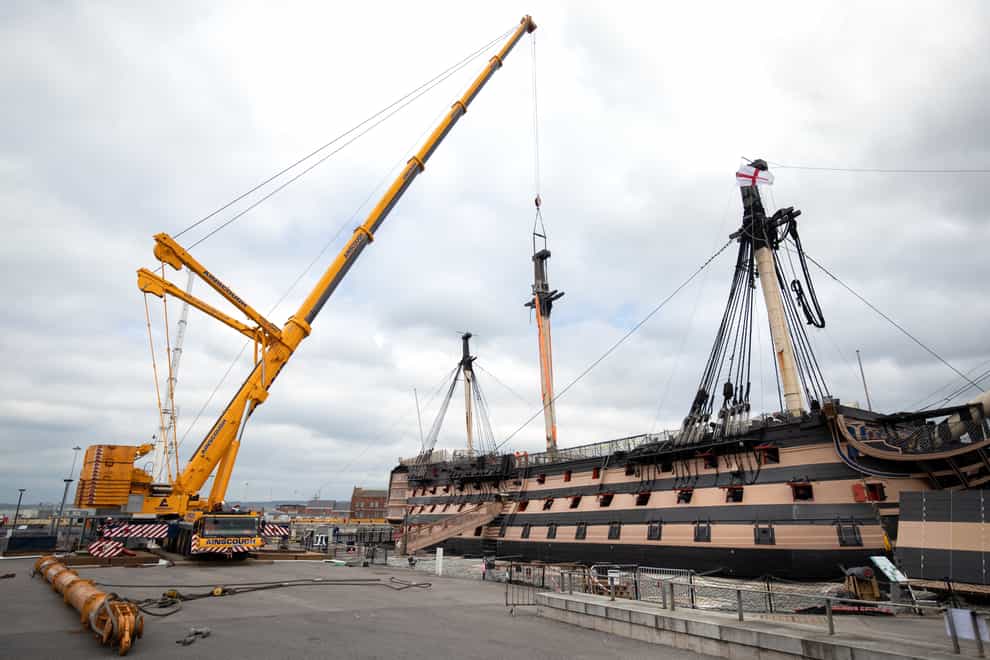 A crane begins the process of removing the main lower mast from HMS Victory (Andrew Matthews/PA)