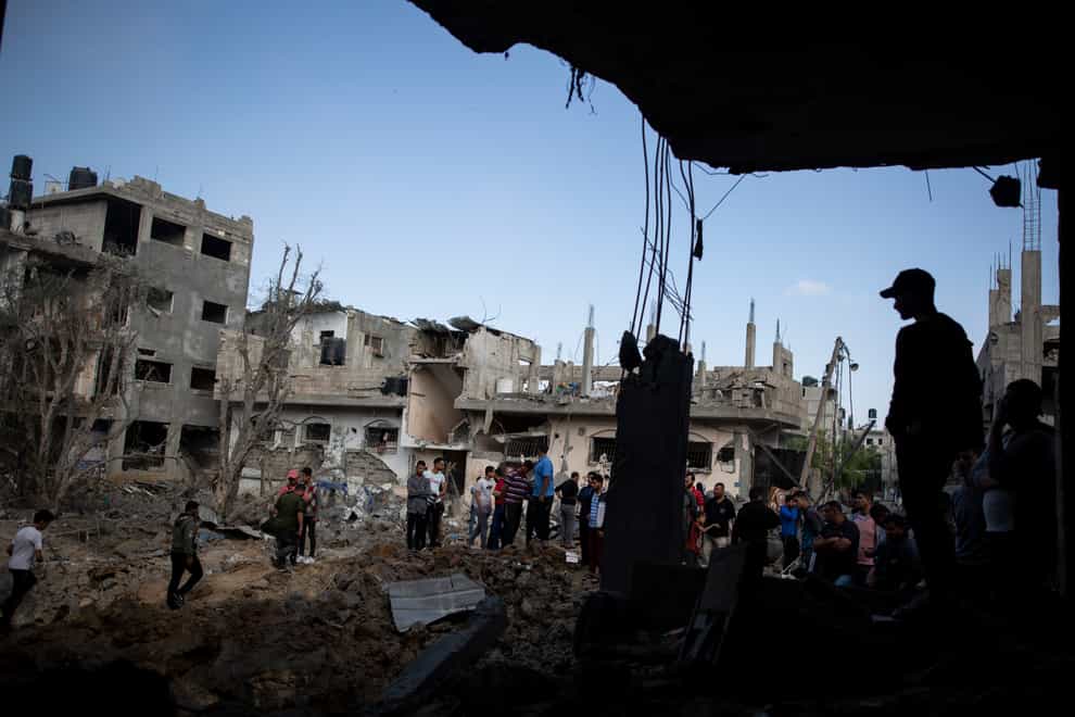 Palestinians inspect their destroyed houses following overnight Israeli air strikes in town of Beit Hanoun, northern Gaza Strip
