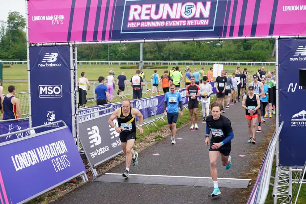 Runners take part in the Reunion 5k run at Kempton Park in Surrey (Yui Mok/PA)