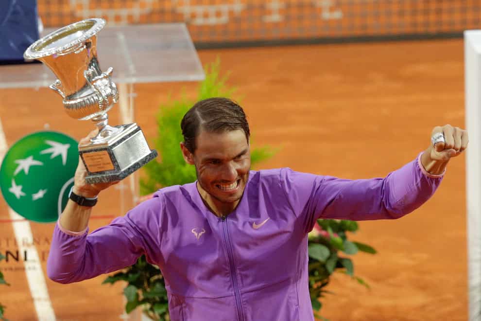 Rafael Nadal celebrates with the trophy after winning his 10th Italian Open title in Rome