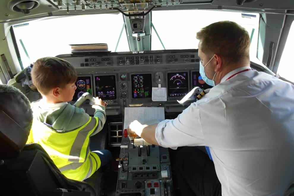 A young boy in an aircraft's cockpit