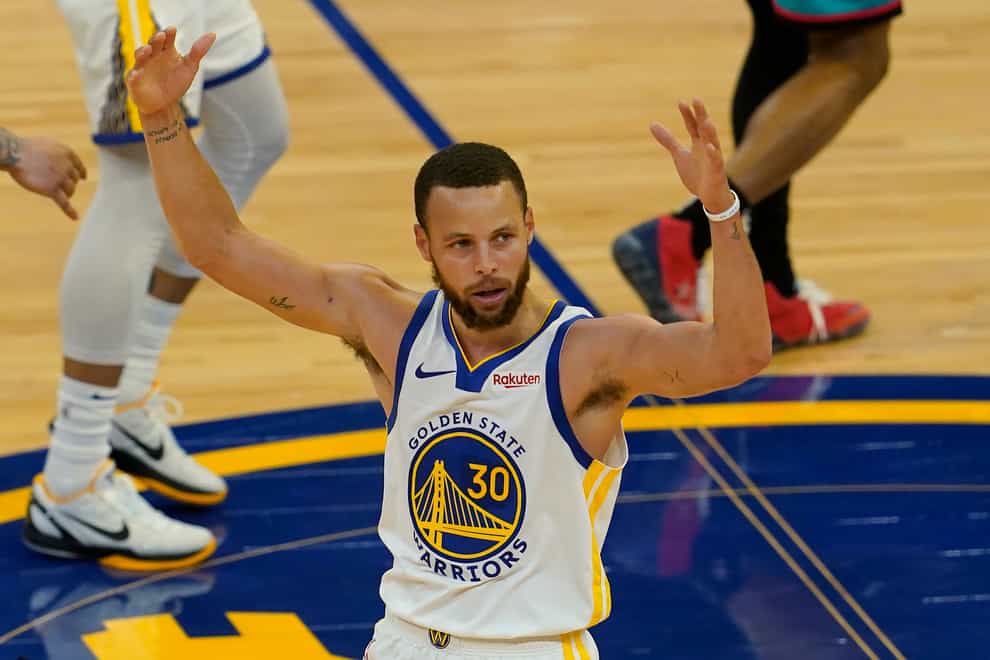 Golden State Warriors guard Stephen Curry gestures after shooting a 3-point basket against the Memphis Grizzlies (Jeff Chiu/AP)