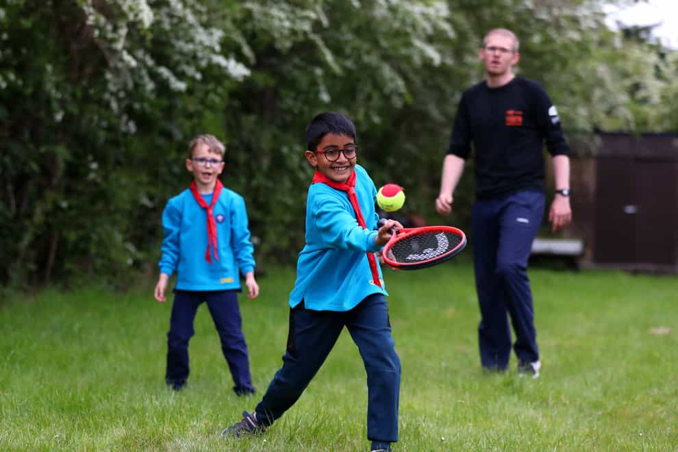 A Beavers group takes part in a tennis activity