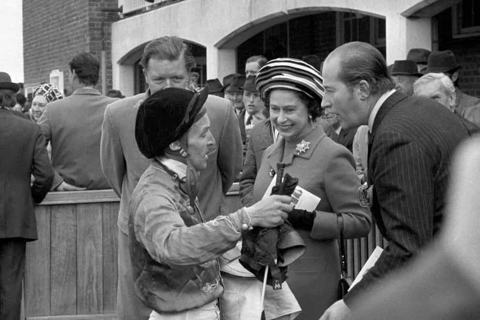 The Queen gets a first-hand account from jockey Joe Mercer after his win on her filly Highclere in the 1000 Guineas