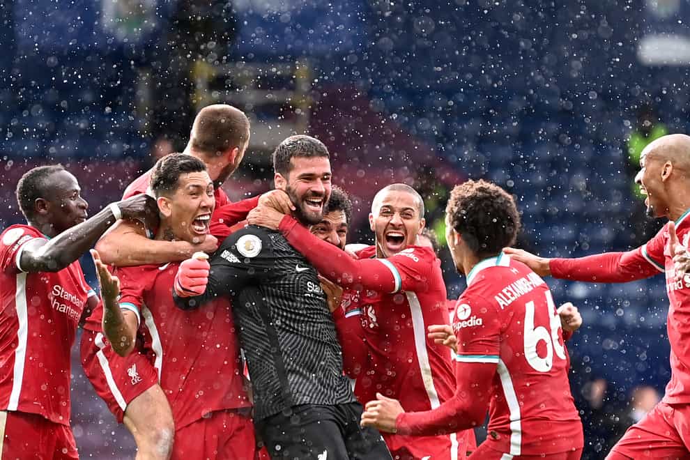 Liverpool goalkeeper Alisson Becker (centre) celebrates his winner