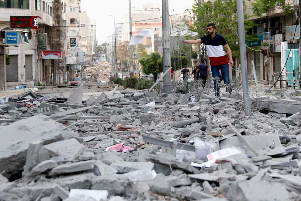 A man stands amid the rubble following an Israeli air strike in Gaza City