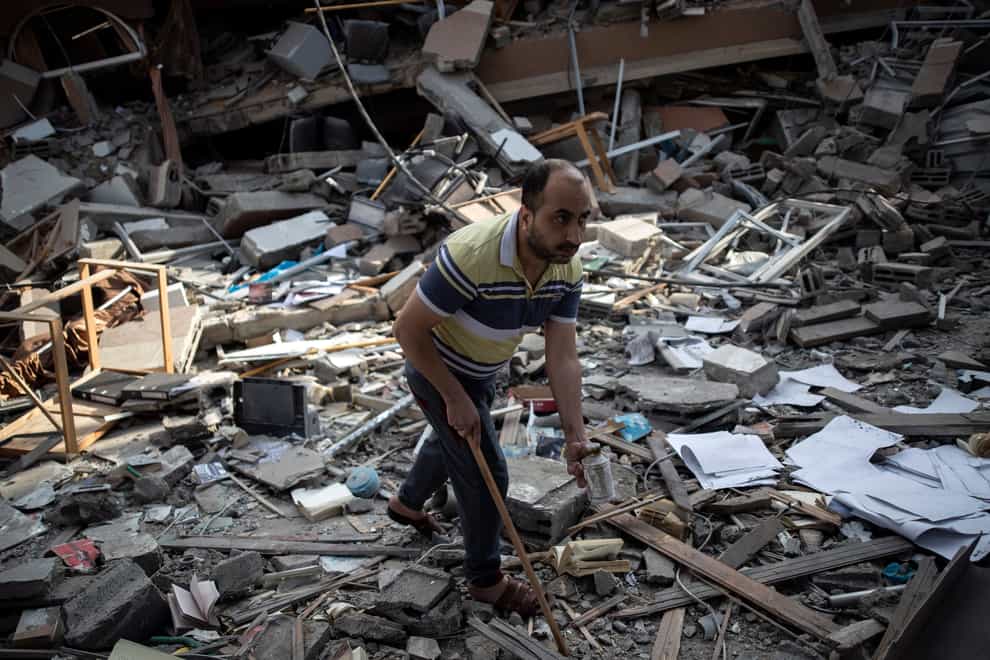 A Palestinian man inspects the damage of a house destroyed by an early morning Israeli airstrike, in Gaza City