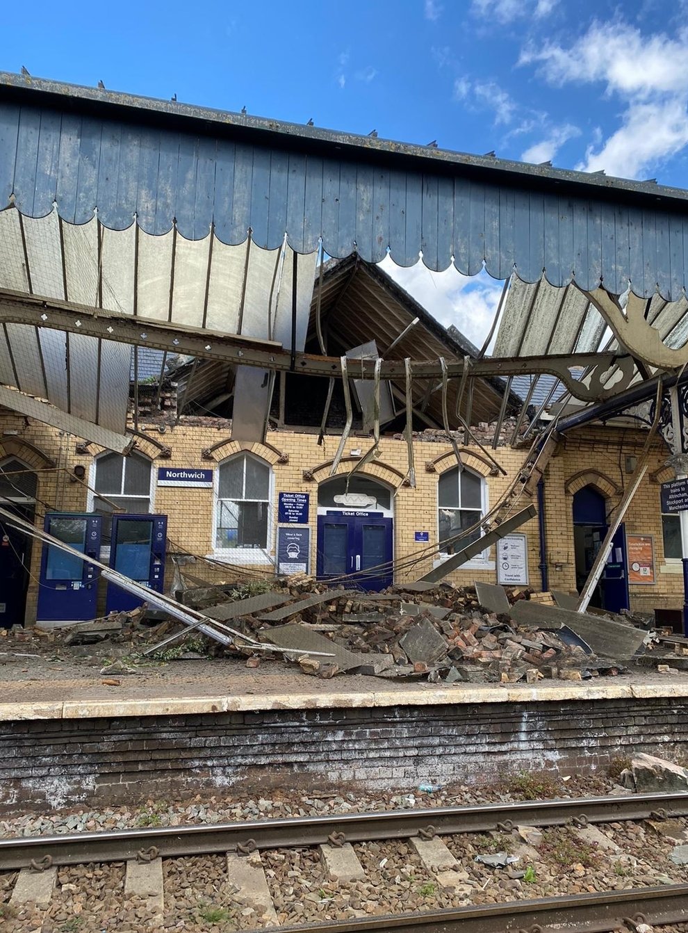Bricks and other building materials crashed onto a railway station platform when a roof and wall collapsed (Northwich fire station/PA)