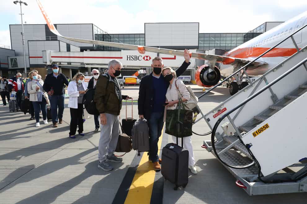 Passengers board a plane at Gatwick Airport