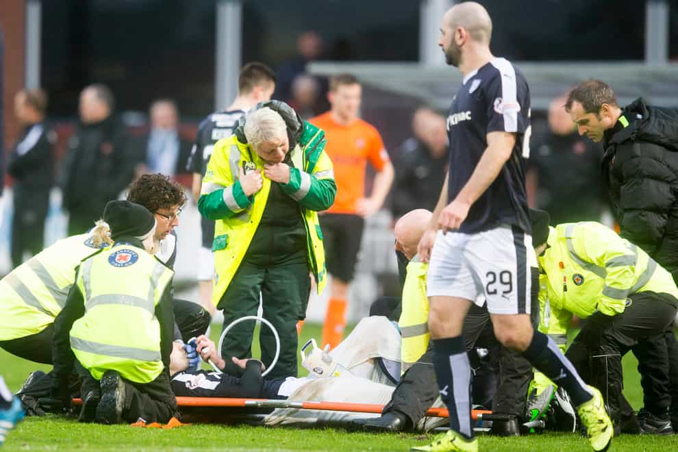 James McPake lies on a stretcher on the pitch