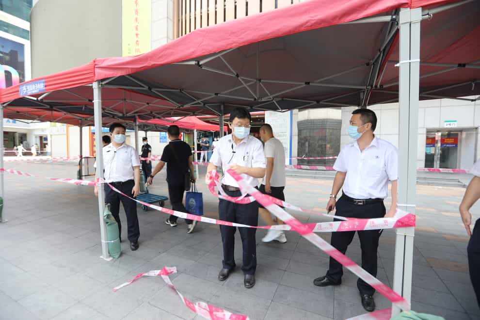 Government officials set up a cordon line at the SEG Plaza in Shenzhen in southern China’s Guangdong Province