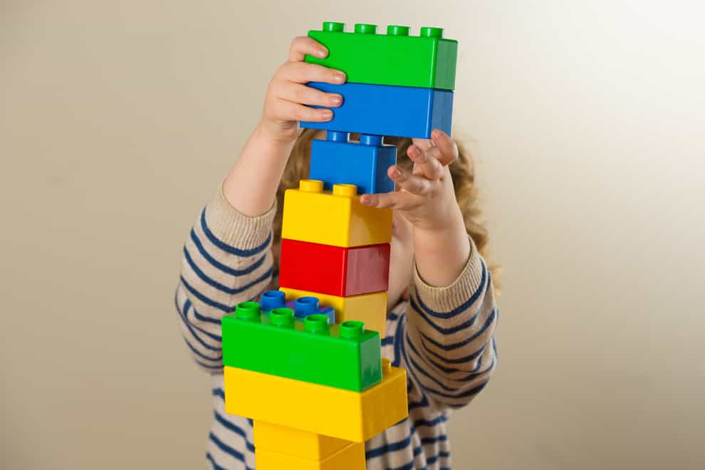 A child plays with plastic building blocks