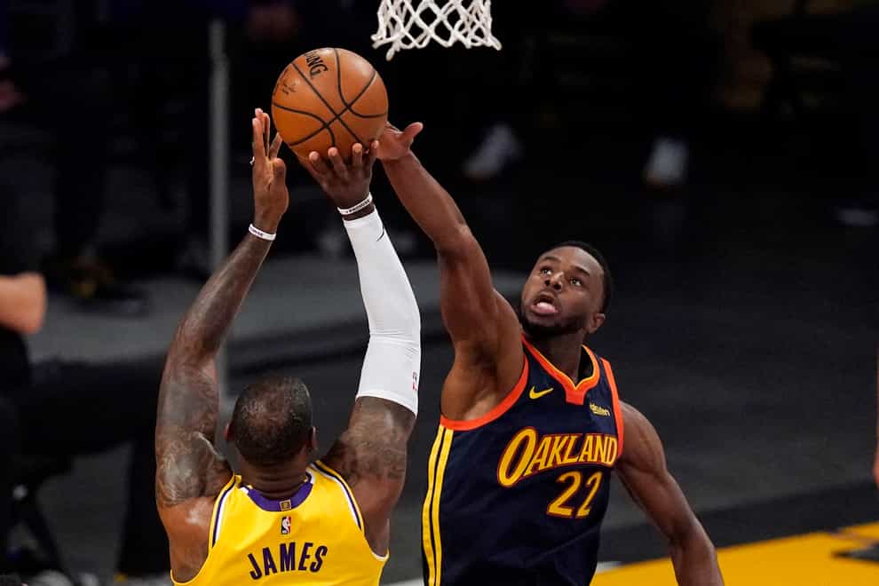Los Angeles Lakers forward LeBron James, left, has his shot blocked by Golden State Warriors forward Andrew Wiggins