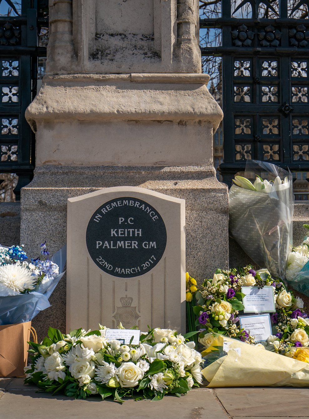 Floral tributes placed around the memorial to honour Pc Keith Palmer (Aaron Chown/PA)