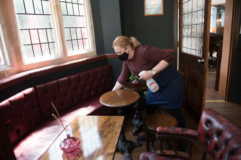 Member of staff cleans table