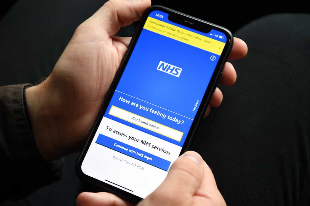 A phone displaying the NHS app