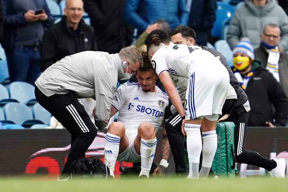 Kalvin Phillips, centre, receives treatment for a shoulder injury