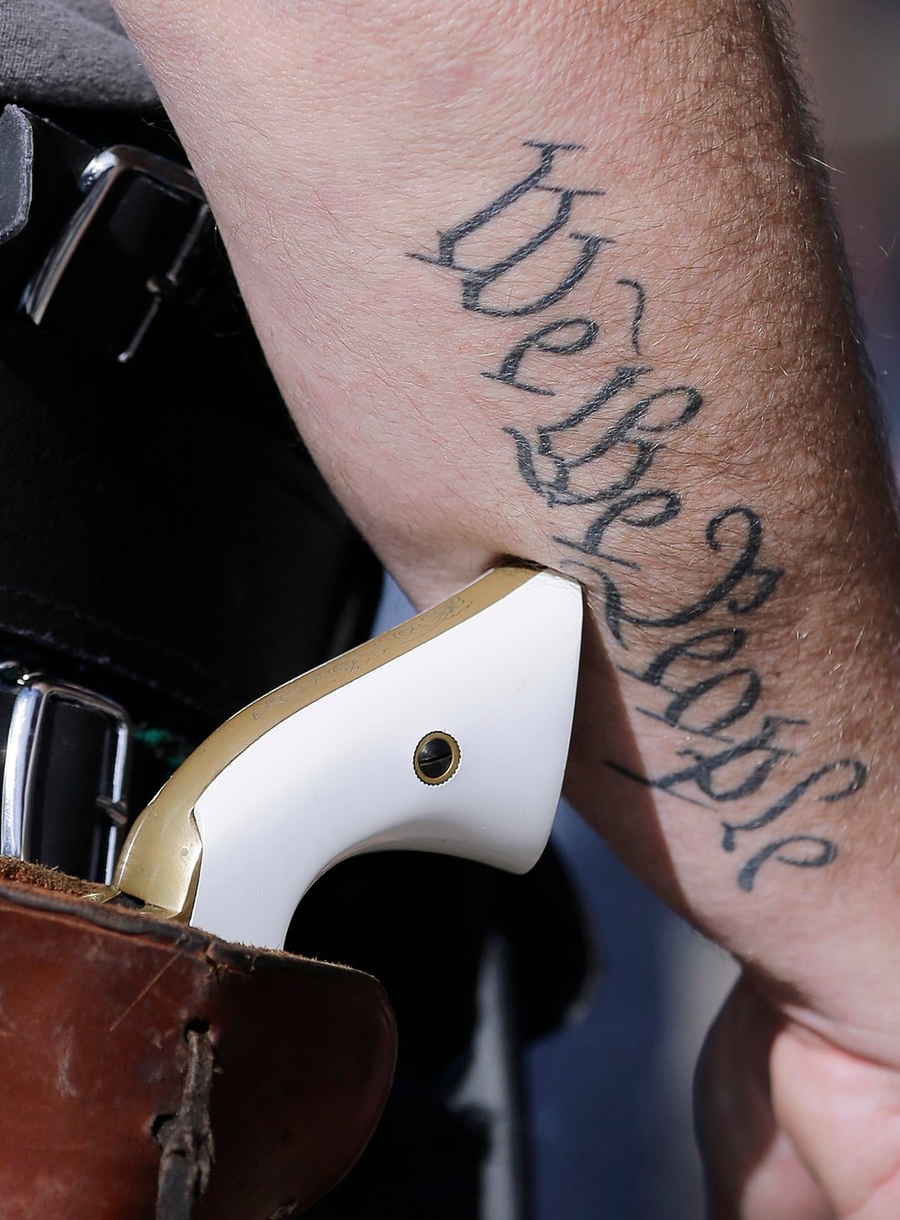 A photo of a handgun on the hip of a supporter of open carry gun laws at a rally in Austin