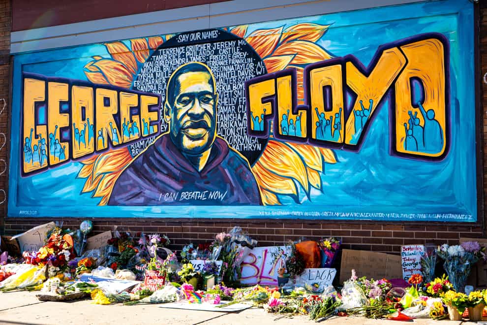 George Floyd mural with flowers laid in front
