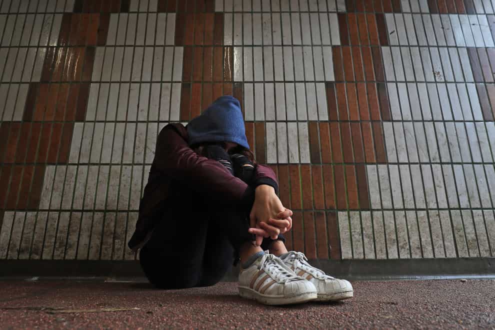 Picture posed by a model of a teenage girl showing signs of mental health issues