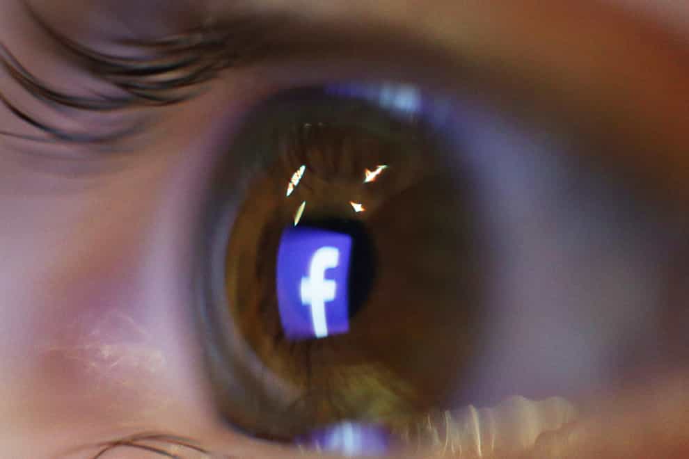The Facebook logo reflected in an eye