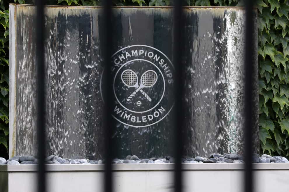 The Wimbledon logo seen through railings