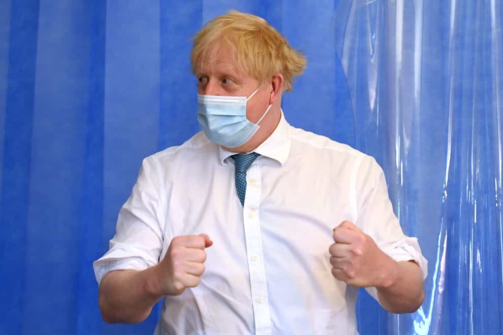 Boris Johnson in a facemask with his sleeves rolled up during a hospital visit