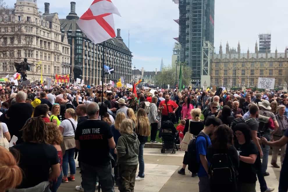 People take part in an anti-vaccine protest in Parliament Square