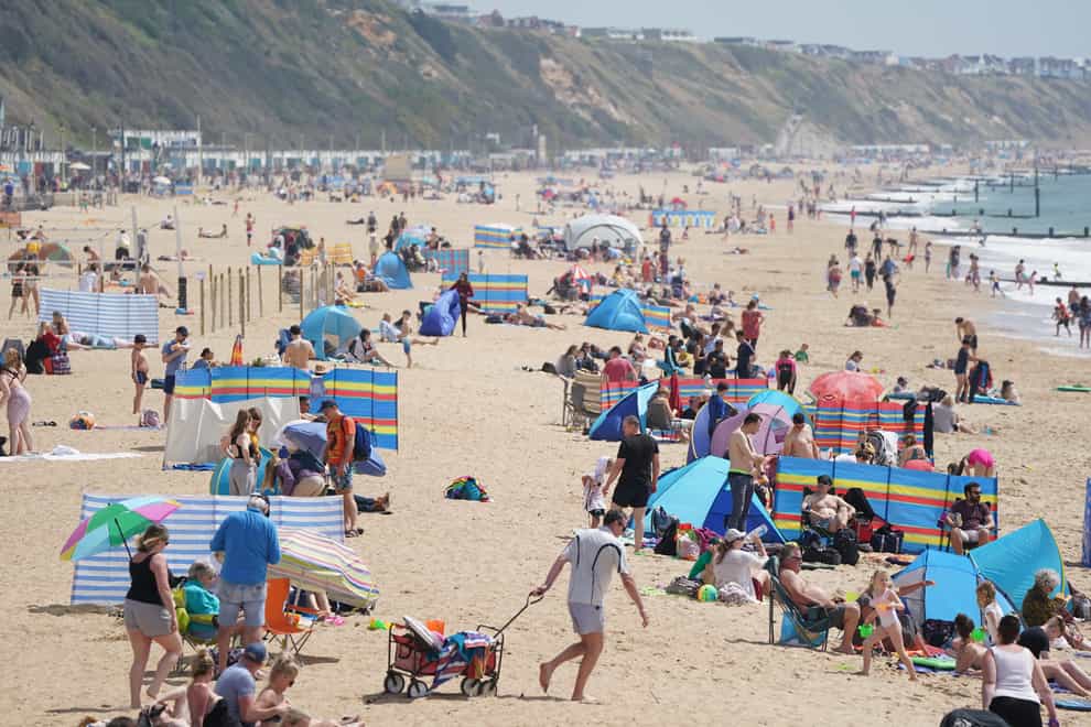 People on Boscombe beach in Bournemouth enjoying the summer sun