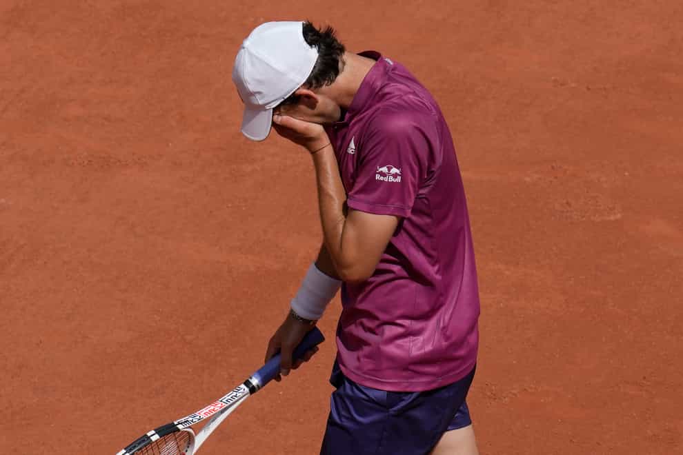 Dominic Thiem puts his head in his hands during his loss to Pablo Andujar